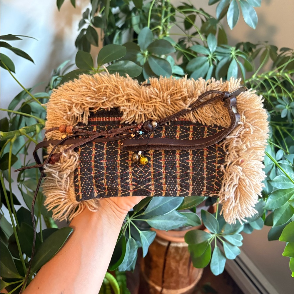 Fuzzy lined clutch with woven and leather details